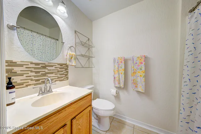 a bathroom with a sink mirror vanity and toilet