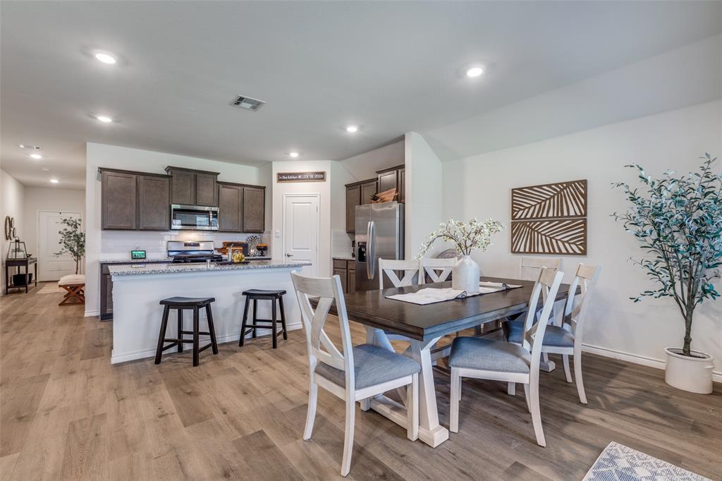 708 Cool Cyn Trail Princeton, TX 75407 - Photo 13 of 28 a view of a dining room with furniture and wooden floor