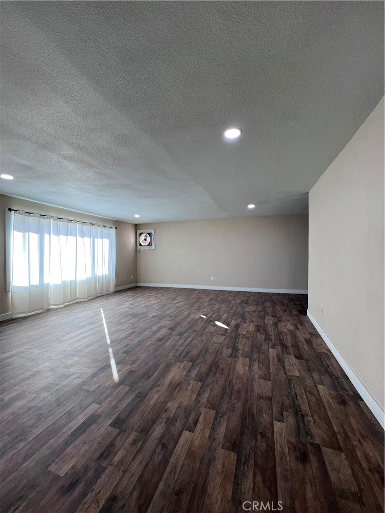 25346 Agate Road Barstow, CA 92311 - Photo 4 of 10 a view of empty room with wooden floor and fan