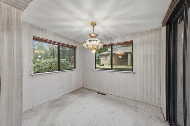 a view of livingroom with window and hallway