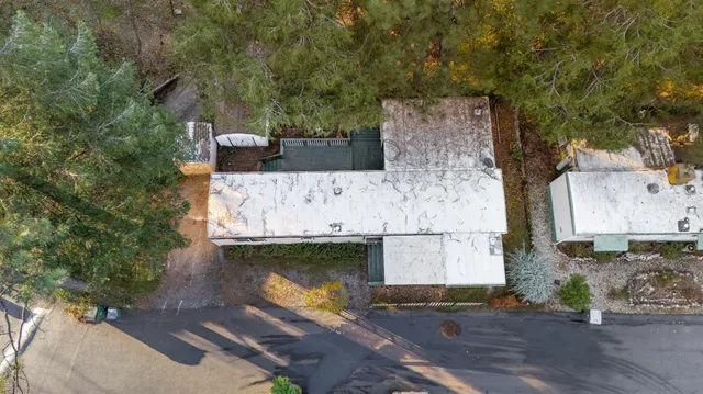 an aerial view of a house with a yard