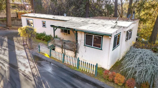 a view of a house with wooden fence