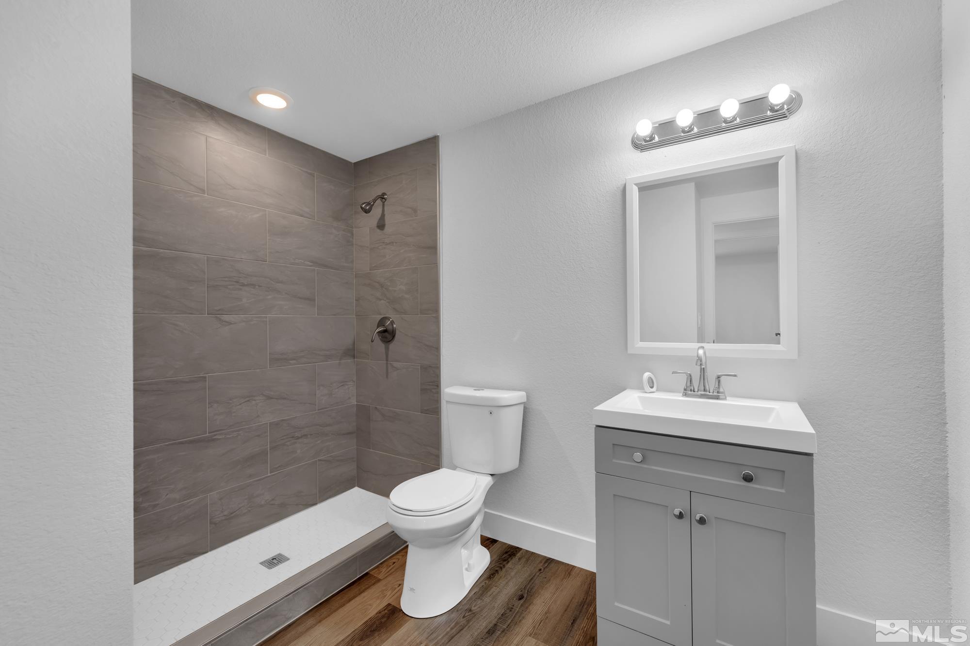 1750 Carlin Street Reno, NV 89503 - Photo 15 of 38 a bathroom with a toilet sink and a mirror