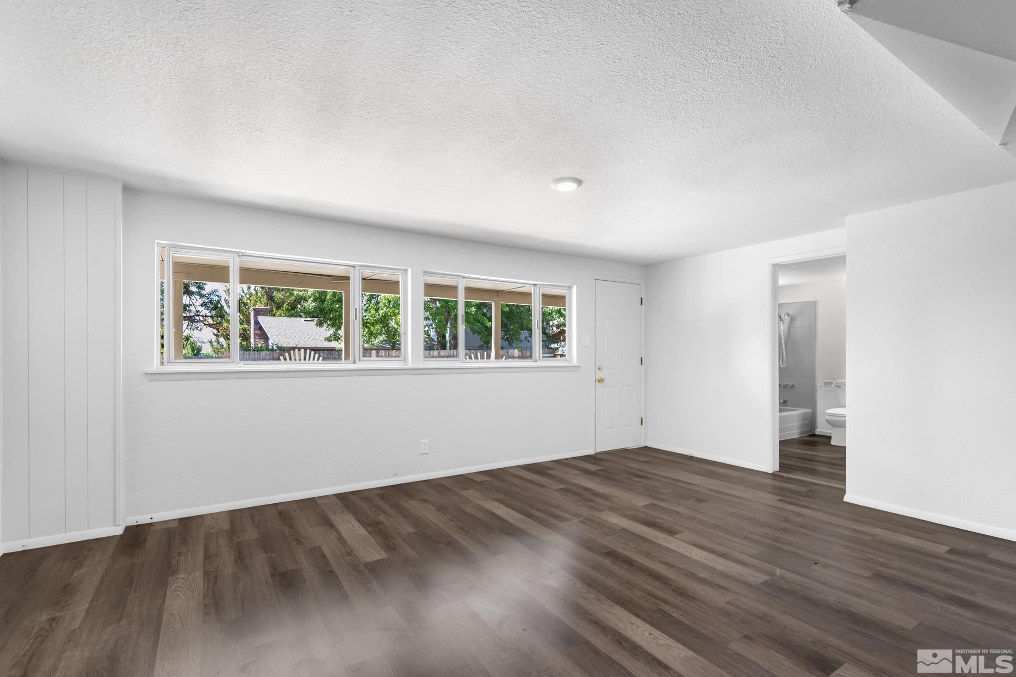 1750 Carlin Street Reno, NV 89503 - Photo 19 of 38 a view of an empty room with wooden floor and a window
