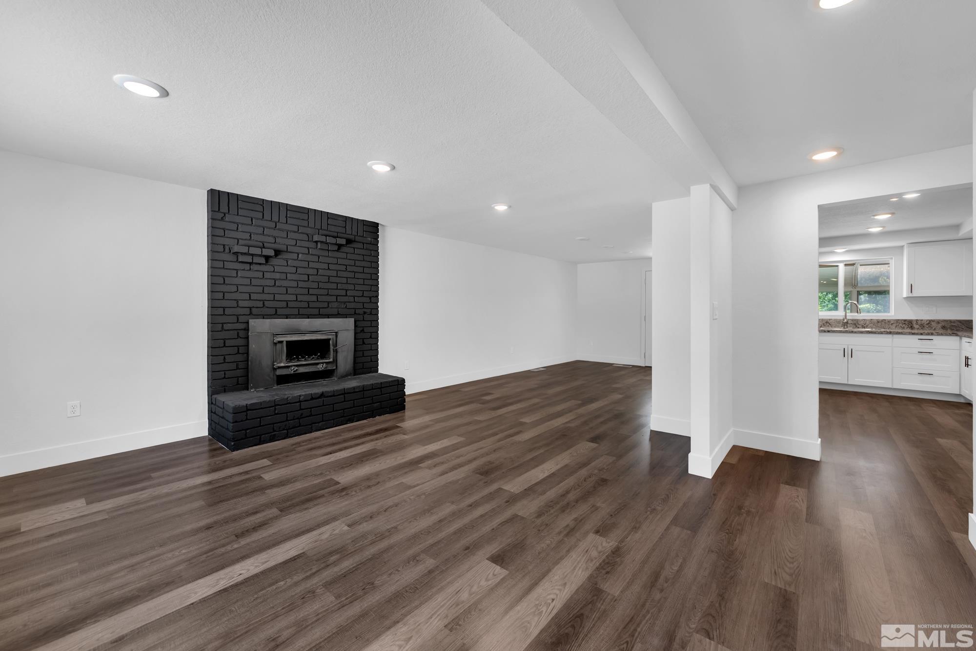 1750 Carlin Street Reno, NV 89503 - Photo 3 of 38 a view of empty room with wooden floor and fireplace
