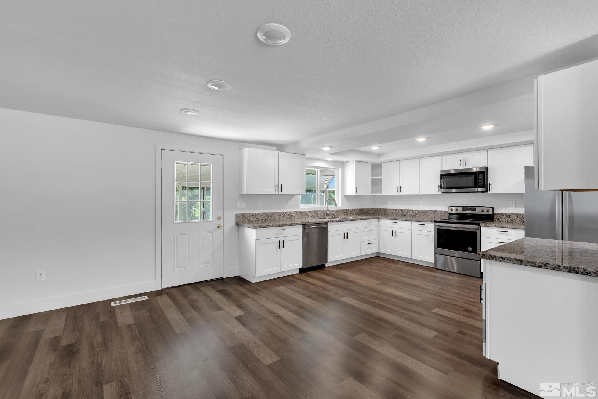 1750 Carlin Street Reno, NV 89503 - Photo 4 of 38 a large kitchen with cabinets wooden floor and stainless steel appliances