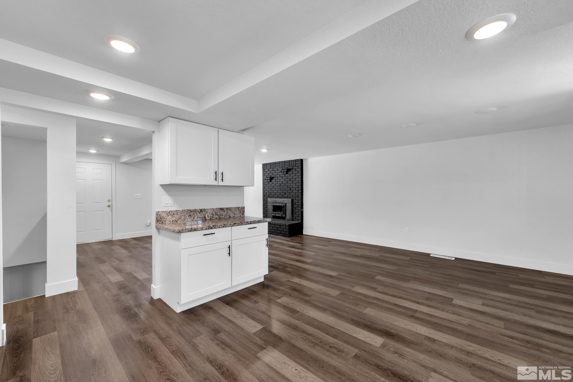 1750 Carlin Street Reno, NV 89503 - Photo 9 of 38 a kitchen with wooden floors and white appliances