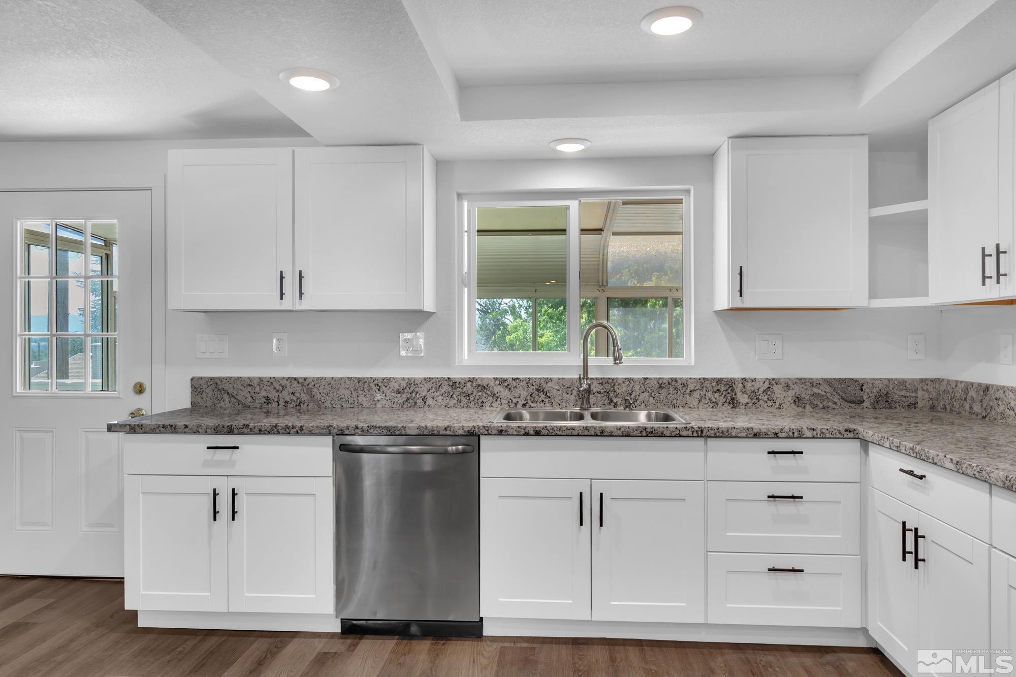 1750 Carlin Street Reno, NV 89503 - Photo 10 of 38 a kitchen with granite countertop white cabinets and a sink