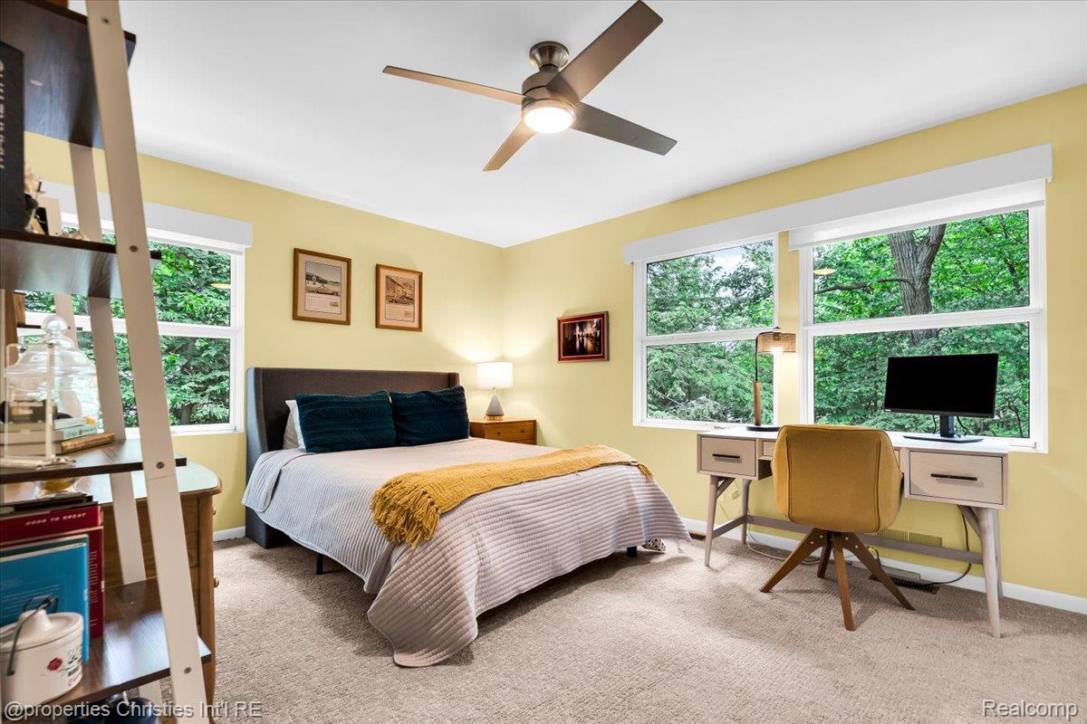 3939 Charing Cross Road Bloomfield Hills, MI 48304 - Photo 23 of 33 Carpeted room featuring multiple windows with natural light, a ceiling fan with integrated lighting, and painted walls