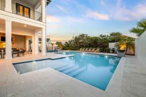 a view of a swimming pool with an outdoor seating