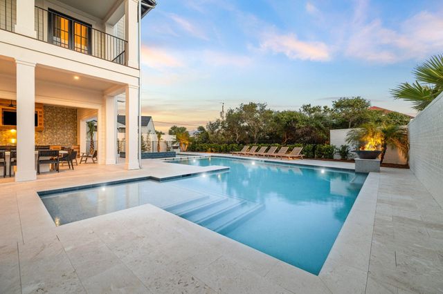 a view of a swimming pool with an outdoor seating
