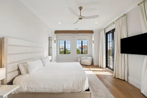 a bedroom with a large bed and a flat screen tv