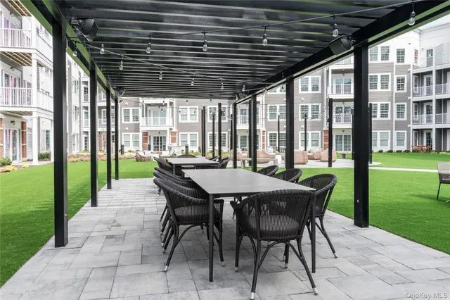a view of a patio with a table chairs and a backyard