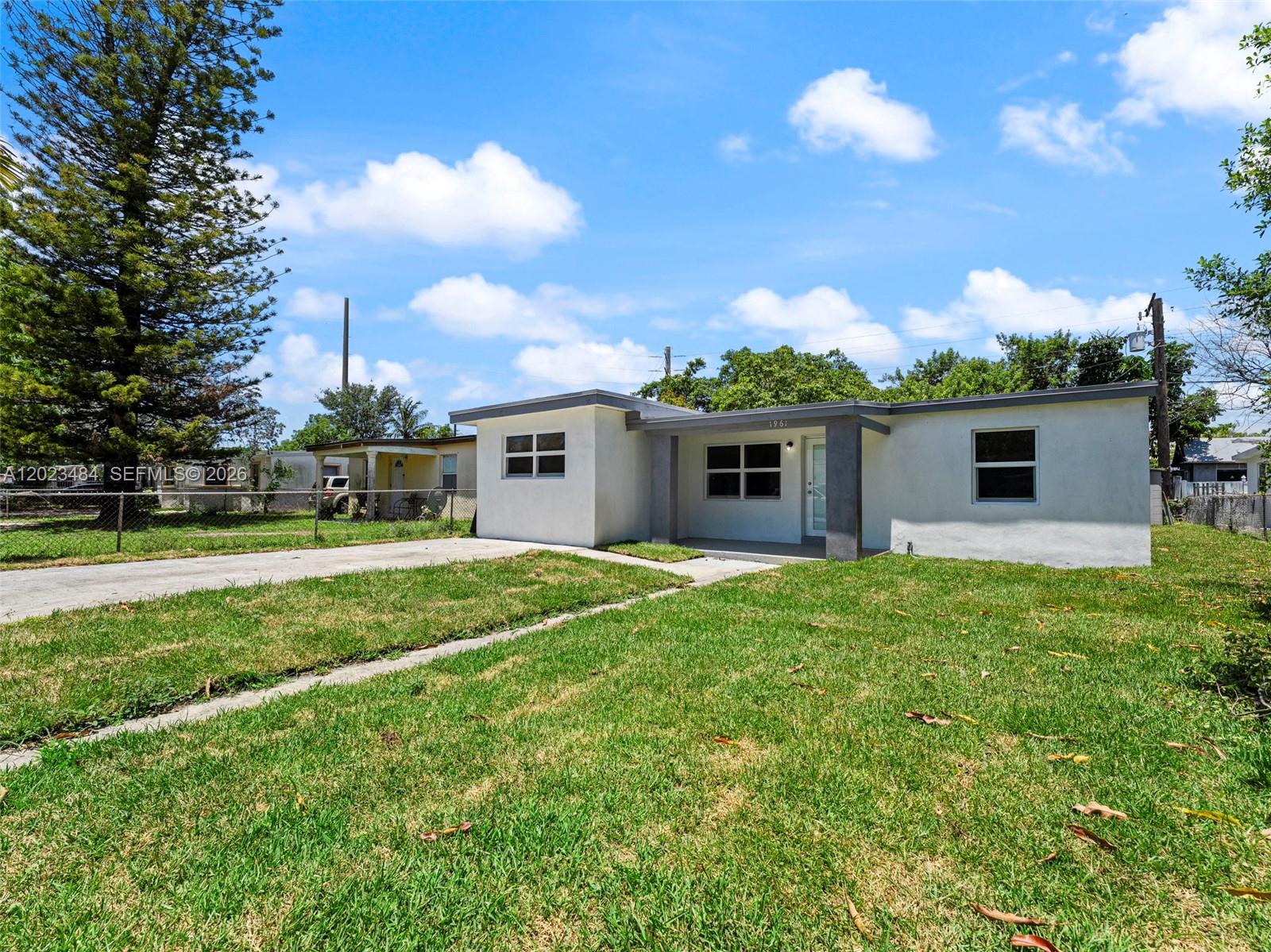 1961 Rutland Street Opa-Locka, FL 33054 - Photo 4 of 33 a front view of house with yard and green space