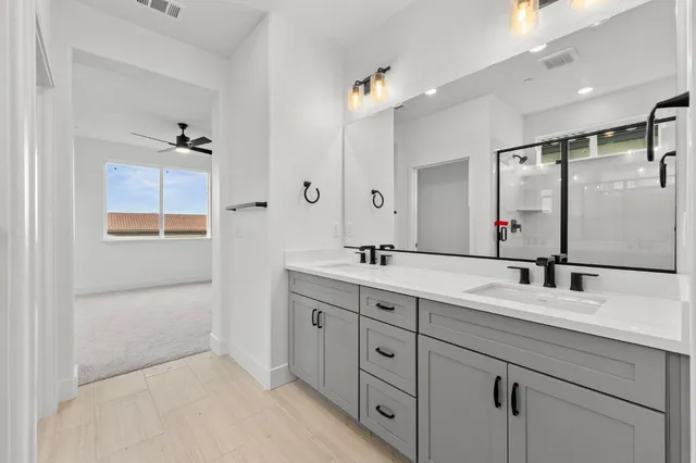 a bathroom with a shower sink and mirror