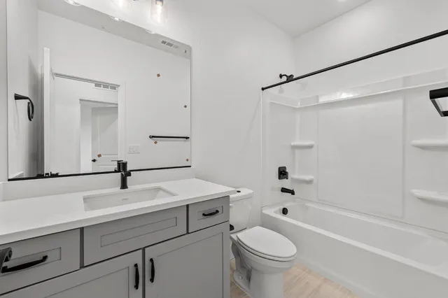 a bedroom with a bed and wall painting with wooden floor