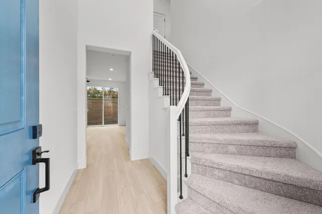 a view of staircase with white walls and windows