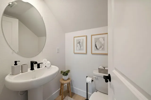 a bedroom with a bed window and a mirror