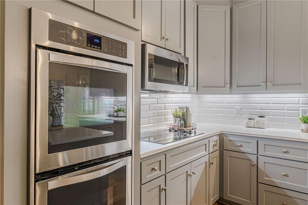 420 Junction Track Roswell, GA 30075 - Photo 14 of 45 a kitchen with stainless steel appliances granite countertop white cabinets and a sink