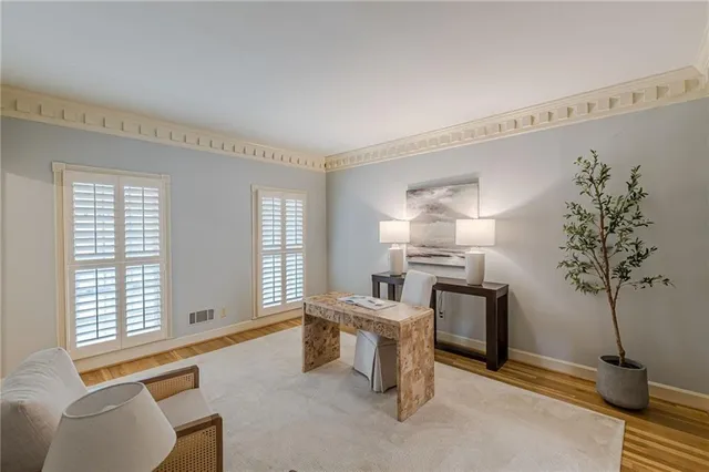 a living room with furniture and a lamp
