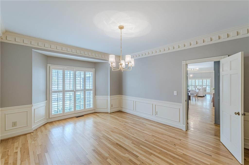 420 Junction Track Roswell, GA 30075 - Photo 19 of 45 a view of an empty room with wooden floor and a window