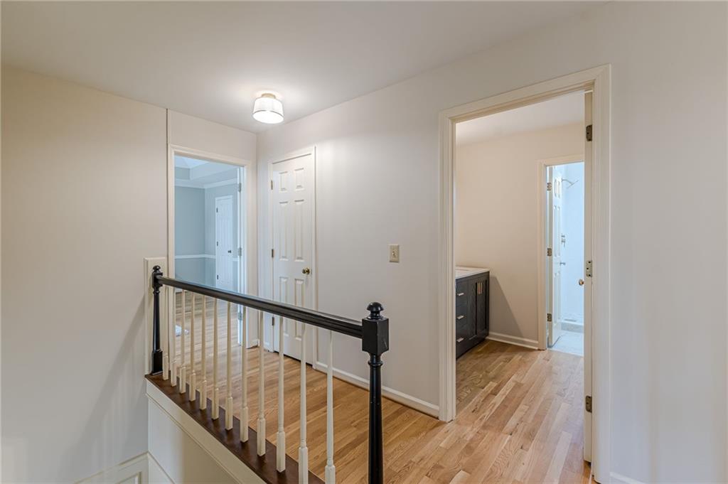 420 Junction Track Roswell, GA 30075 - Photo 20 of 45 a view of a hallway with wooden floor and staircase