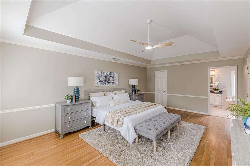 420 Junction Track Roswell, GA 30075 - Photo 21 of 45 a spacious bedroom with a bed and a chandelier