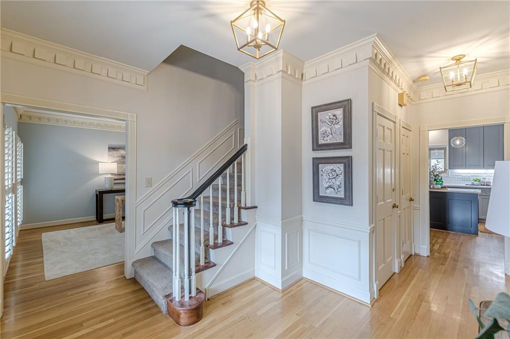 420 Junction Track Roswell, GA 30075 - Photo 3 of 45 a view of a hallway with wooden floor and staircase