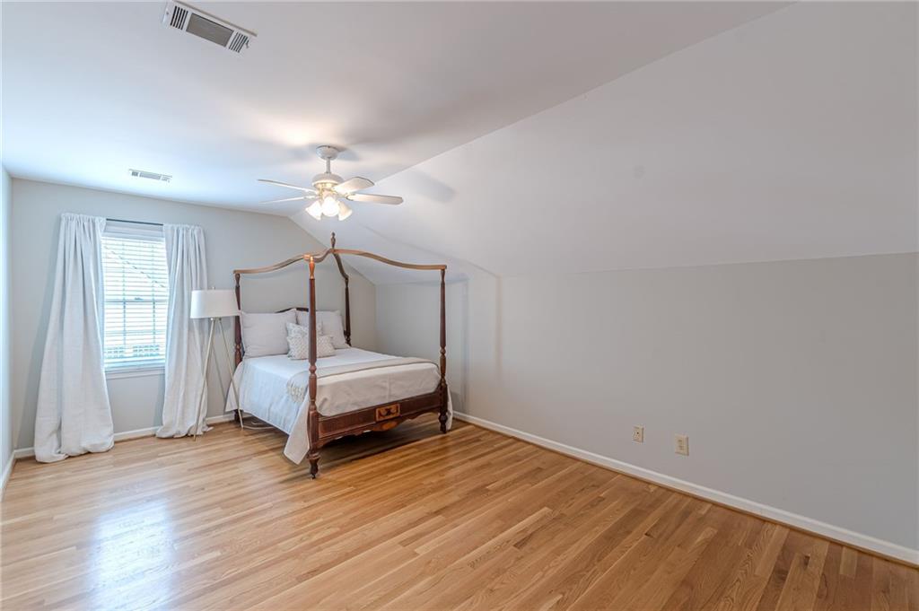 420 Junction Track Roswell, GA 30075 - Photo 32 of 45 a bedroom with a bed and a chandelier