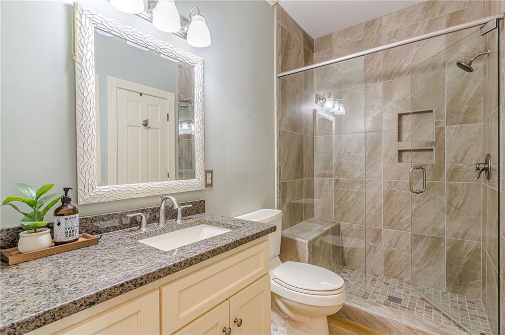 420 Junction Track Roswell, GA 30075 - Photo 33 of 45 a bathroom with a granite countertop sink a toilet and shower
