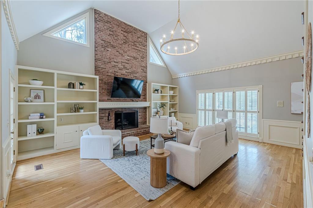 420 Junction Track Roswell, GA 30075 - Photo 5 of 45 a living room with furniture wooden floor and a fireplace