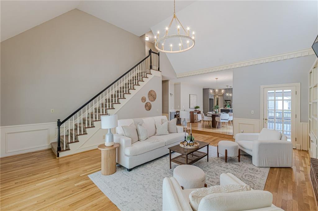 420 Junction Track Roswell, GA 30075 - Photo 6 of 45 a living room with couches a dining table and chairs with wooden floor