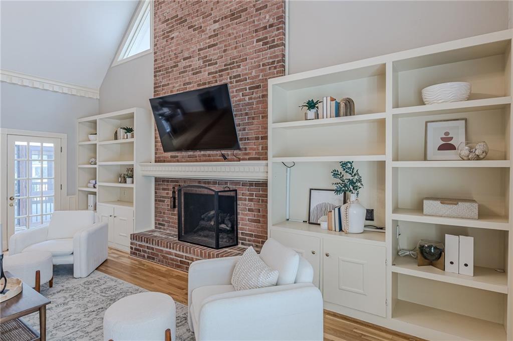 420 Junction Track Roswell, GA 30075 - Photo 7 of 45 a living room with furniture a flat screen tv and a fireplace