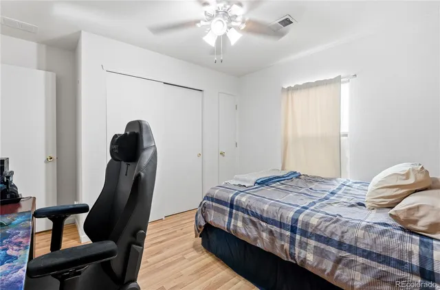 a bedroom with bed and chair