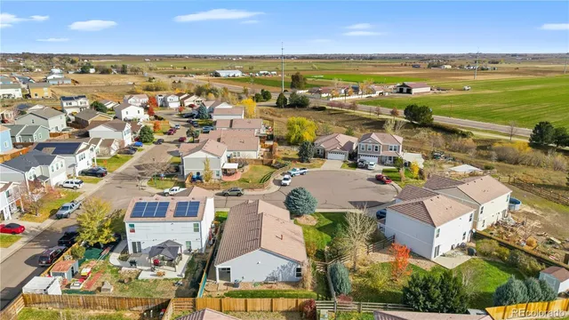 an aerial view of residential building with outdoor space and ocean view