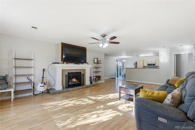a living room with furniture a fireplace and a flat screen tv