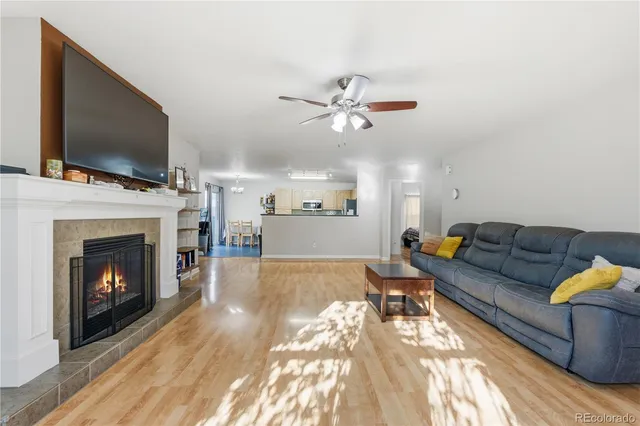 a living room with furniture a flat screen tv and a fireplace