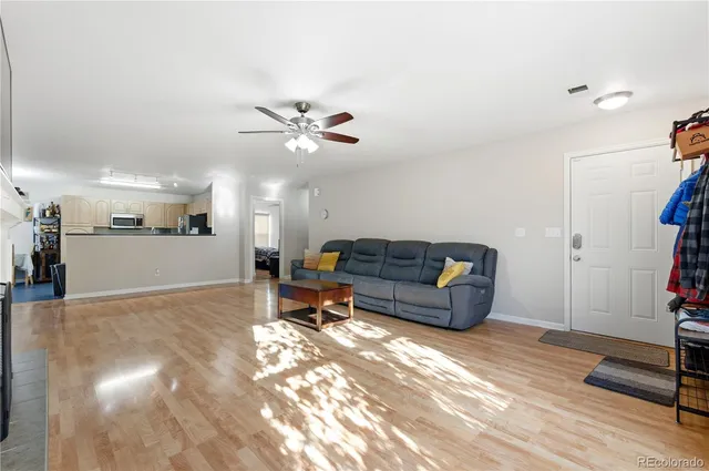 a living room with furniture and a chandelier