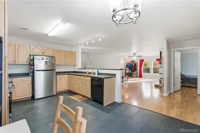 a kitchen with white cabinets and refrigerator