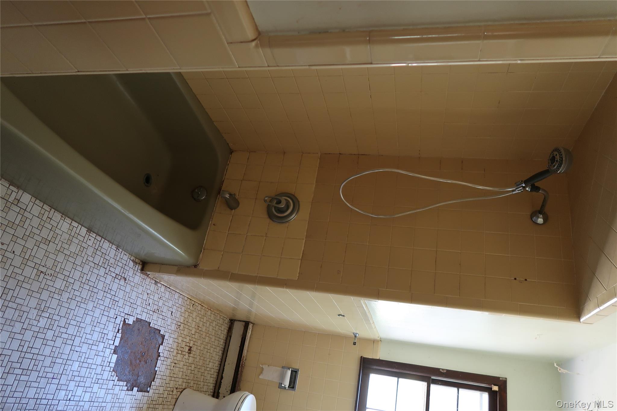 2 Valley View Road Bloomingburg, NY 12721 - Photo 12 of 17 Full bath with tub / shower combination, tile walls, tile patterned flooring, and baseboard heating