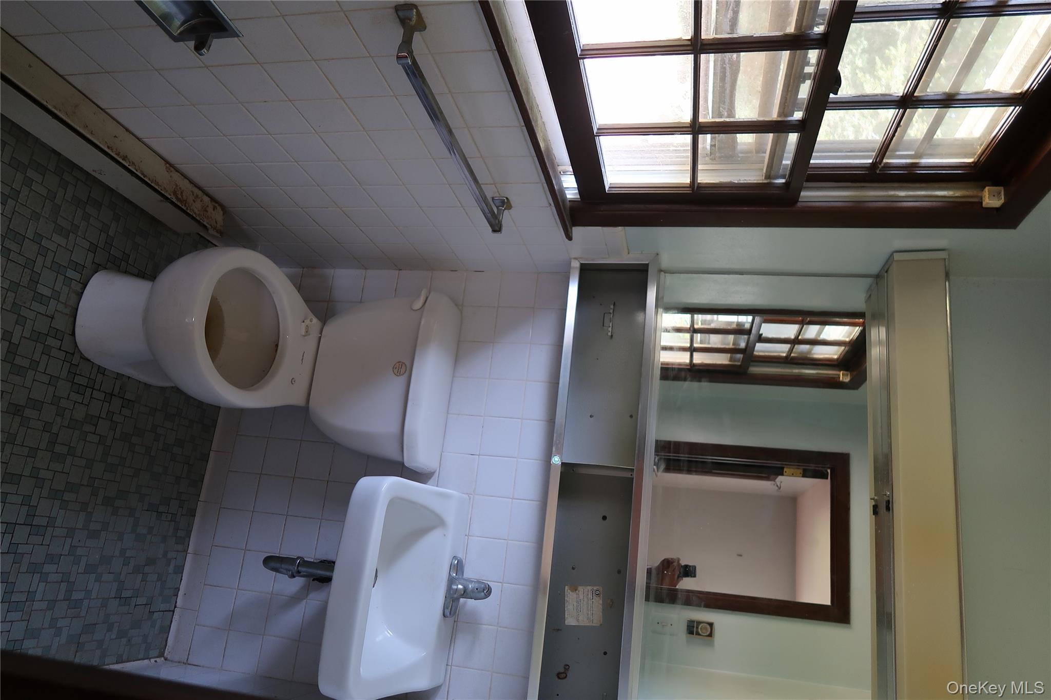 2 Valley View Road Bloomingburg, NY 12721 - Photo 15 of 17 Bathroom with tile walls, dark tile patterned flooring, and a baseboard radiator