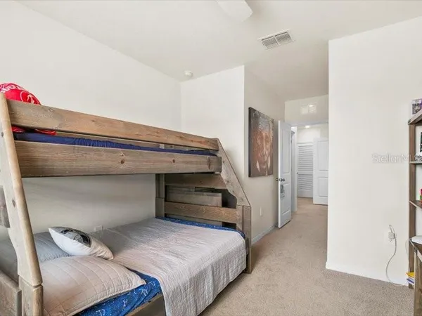 a bedroom with a bed and cabinets