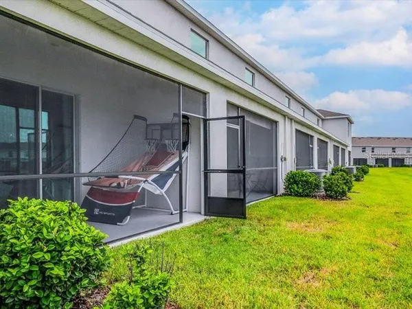 a view of a backyard with plants and a patio