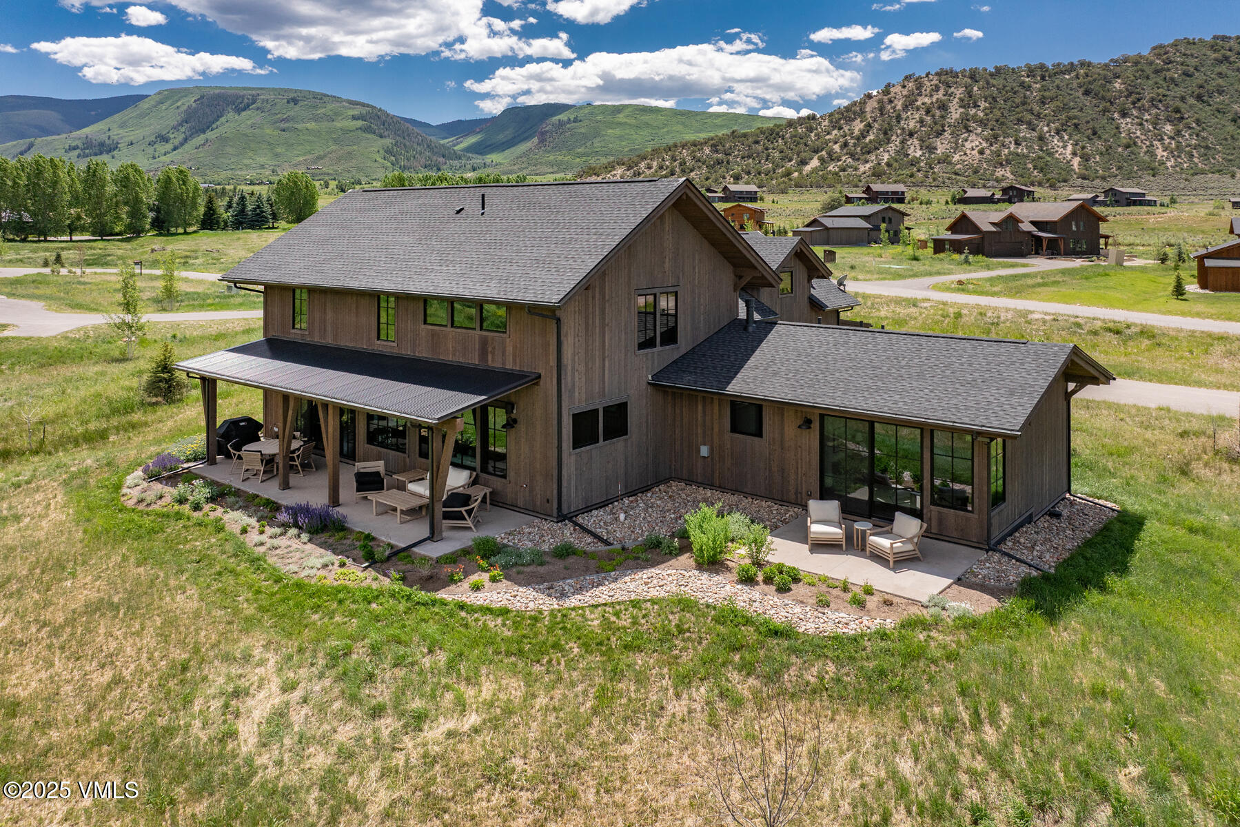 a view of house with outdoor seating yard and mountain view in back