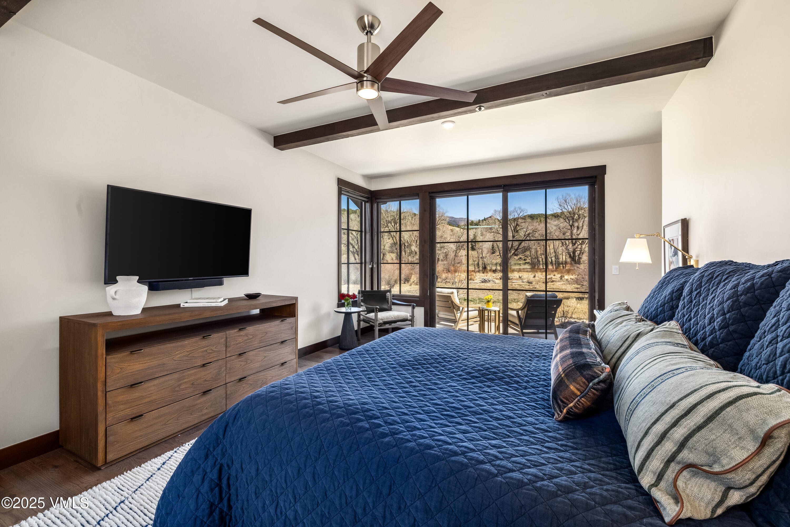 687 Hunters View Lane Eagle, CO 81631 - Photo 14 of 43 a bedroom with a large bed and a flat screen tv