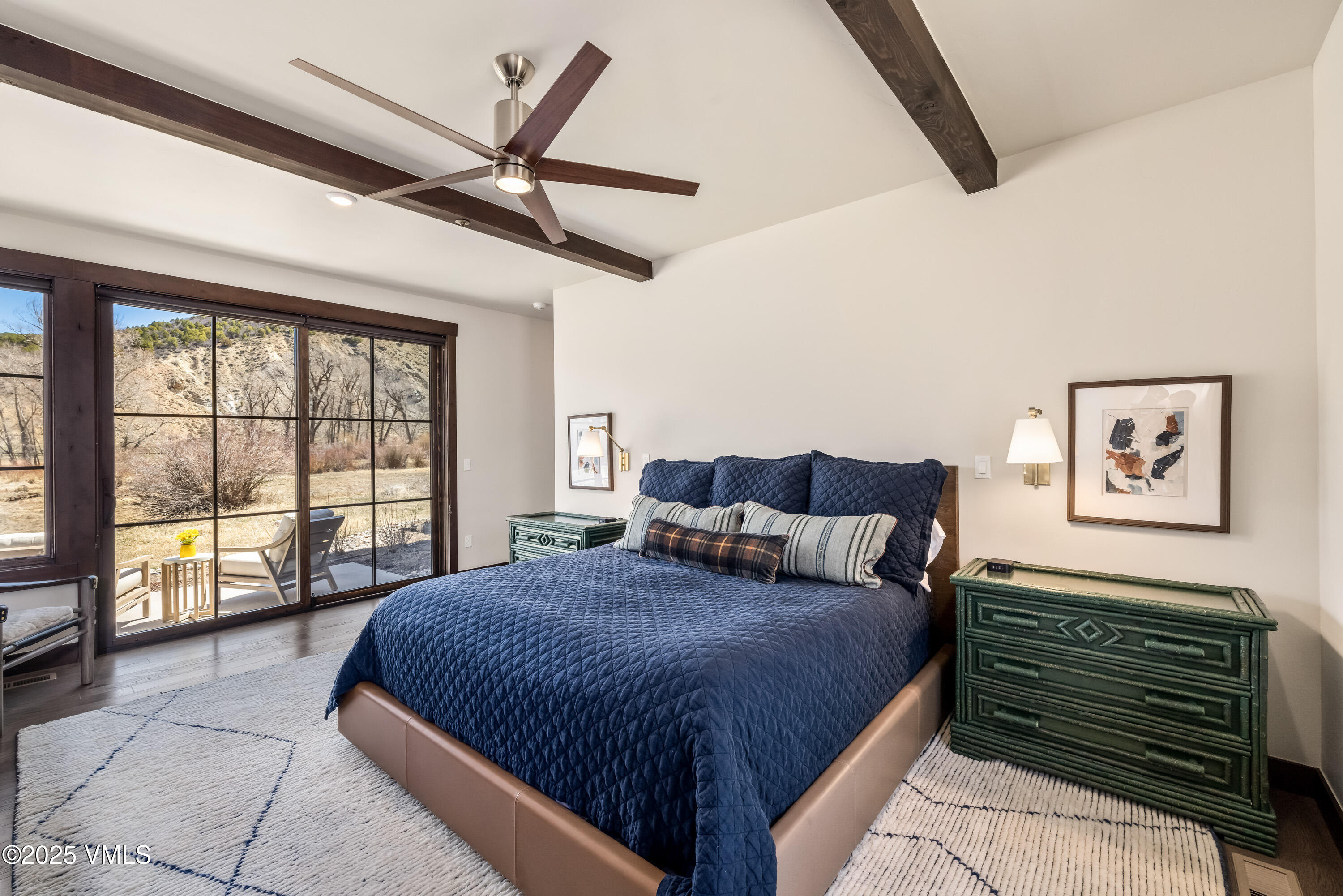 687 Hunters View Lane Eagle, CO 81631 - Photo 15 of 43 a spacious bedroom with a large bed and a large window