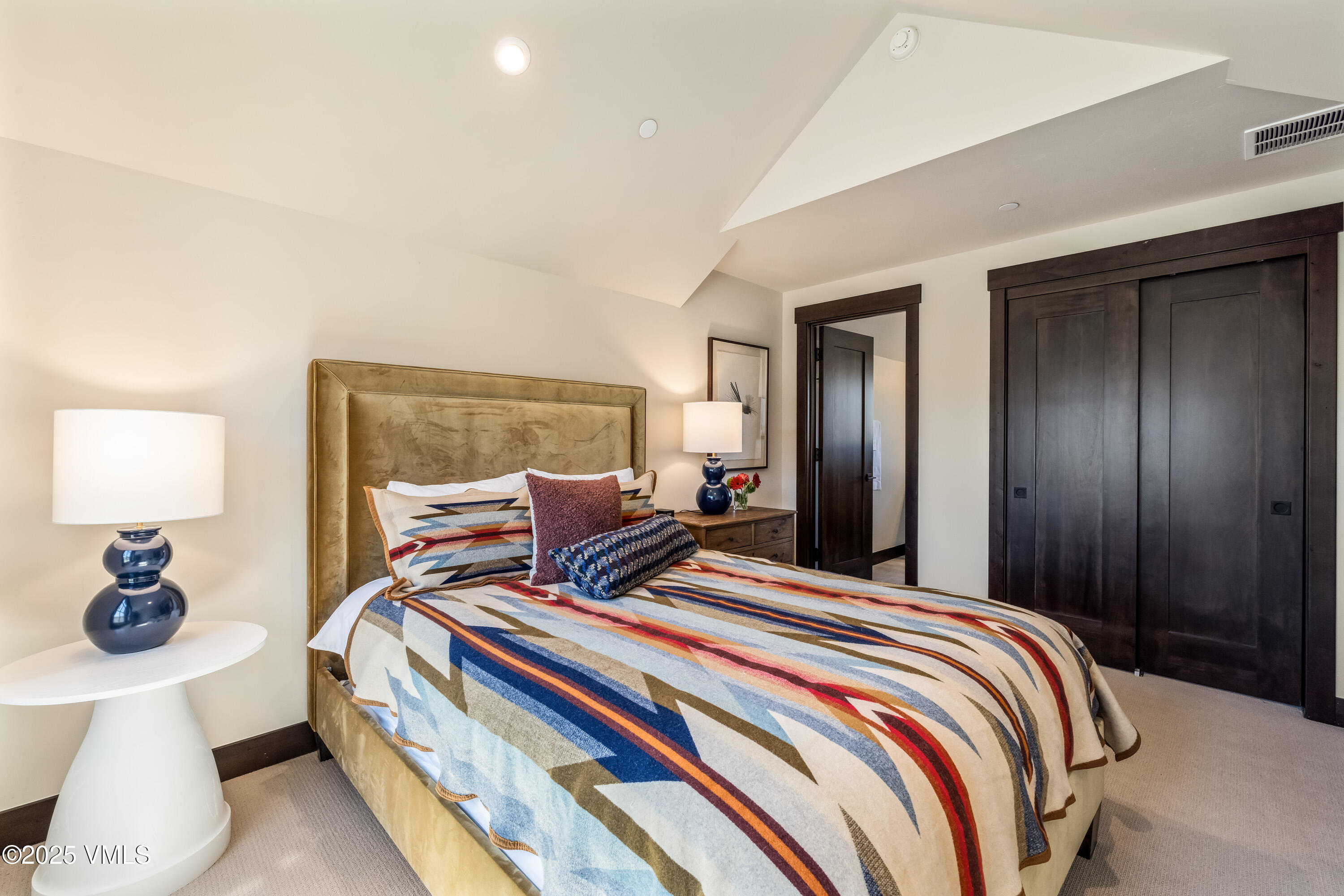 687 Hunters View Lane Eagle, CO 81631 - Photo 24 of 43 a bedroom with a bed and a lamp
