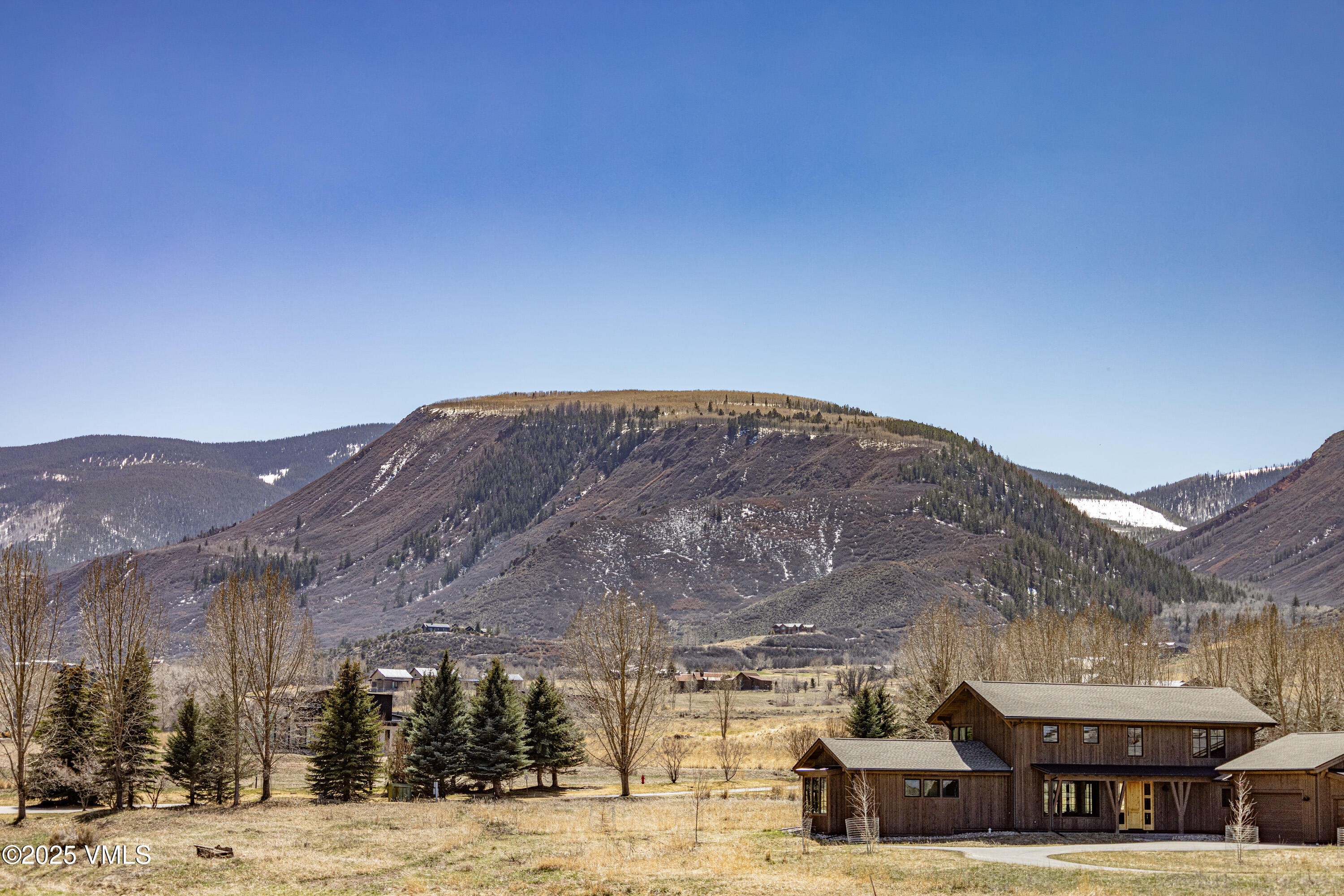 687 Hunters View Lane Eagle, CO 81631 - Photo 32 of 43 a view of a big house with a mountain in the background