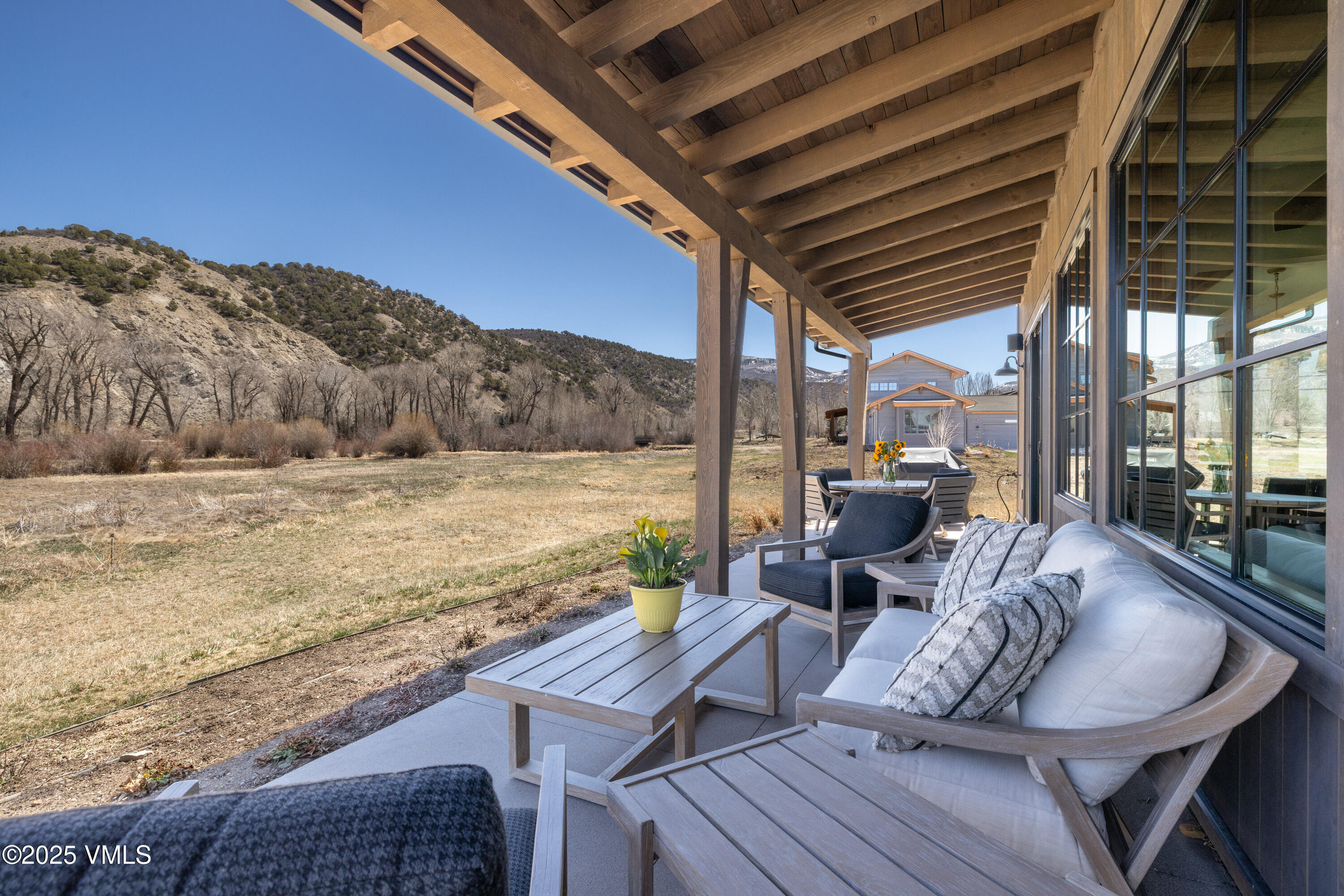687 Hunters View Lane Eagle, CO 81631 - Photo 35 of 43 a view of a balcony with table and chairs with wooden floor and fence