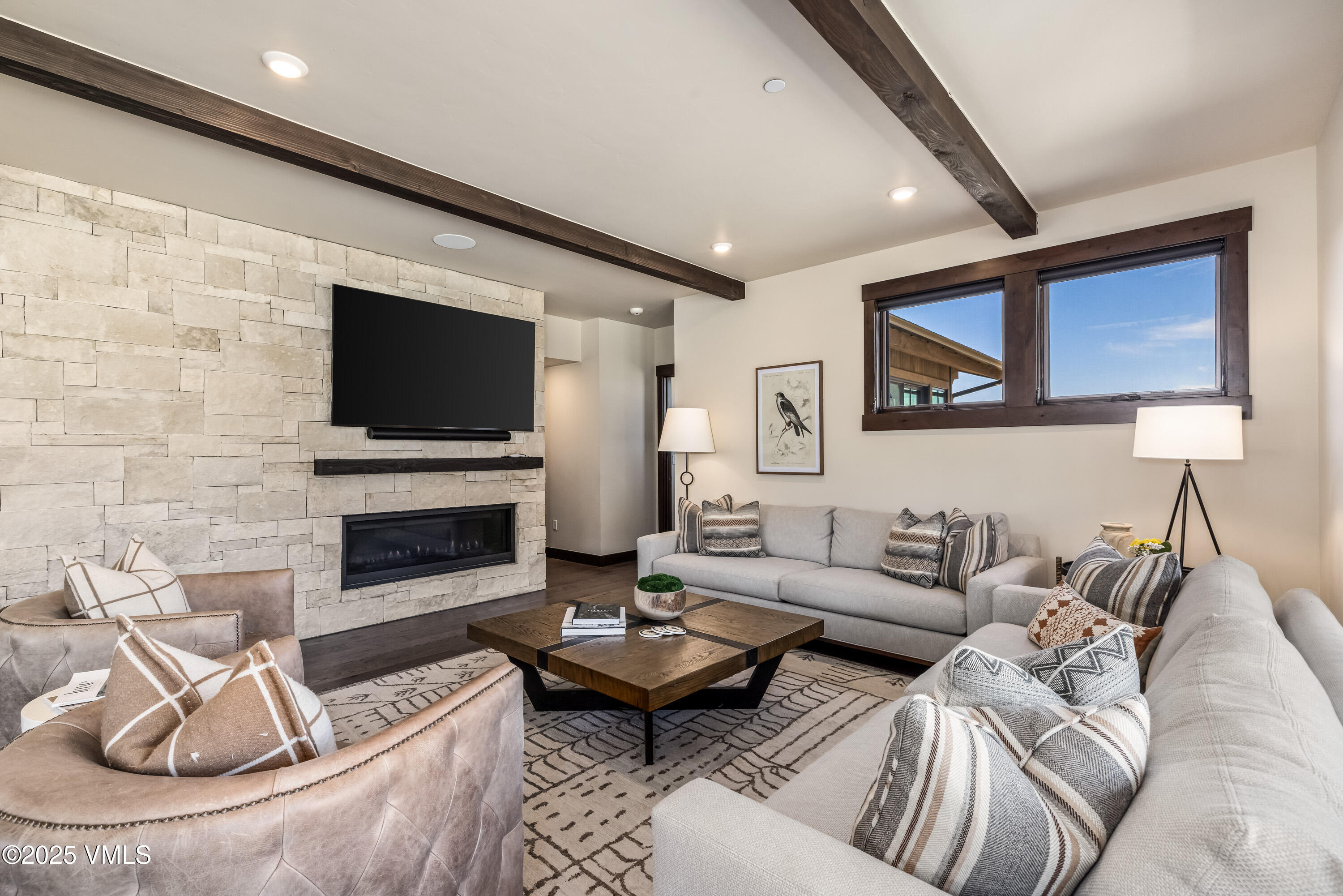 687 Hunters View Lane Eagle, CO 81631 - Photo 8 of 43 a living room with furniture a flat screen tv and a fireplace